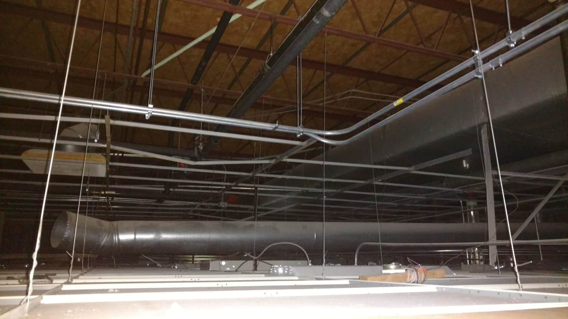 Conduit run through open plenum ceiling.